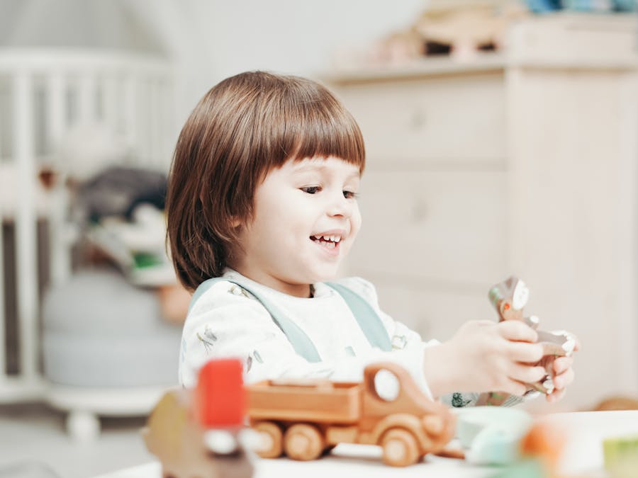 A happy child playing with wooden toys