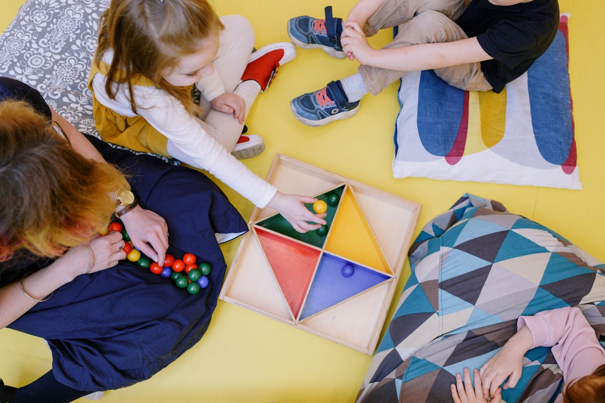 A therapist guiding children through a colourful learning activity